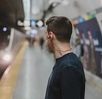 noise canceling earbuds in railways station