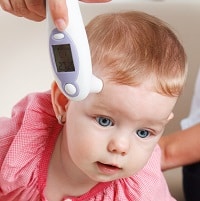 Baby with a thermometer