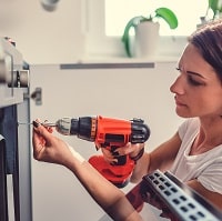 Woman using a cordless drill