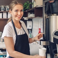 girl using an espresso machine