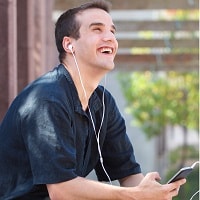 happy man listening to music on earbuds