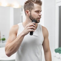 man shaving in front of the mirror